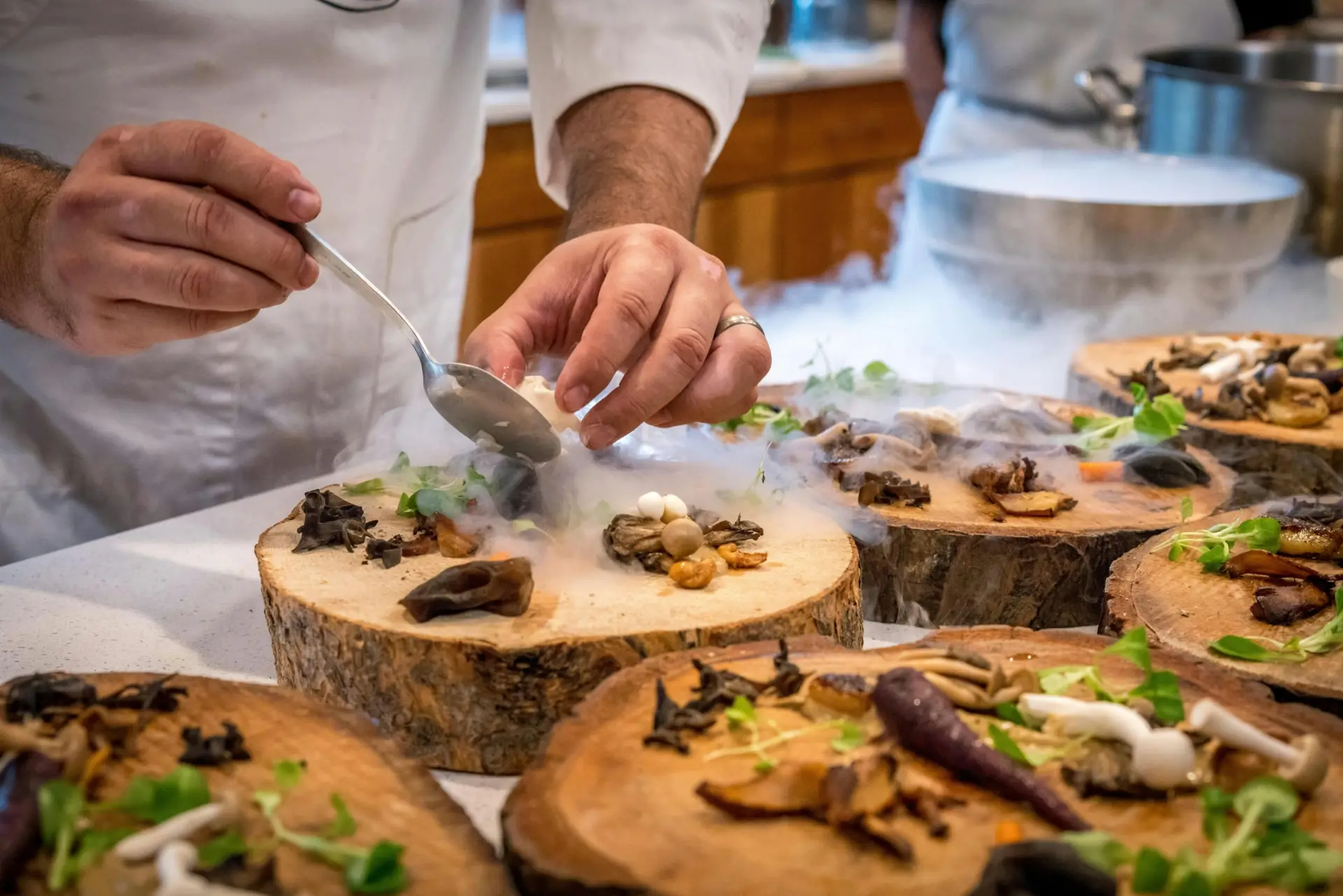 Chef plating dishes in a commercial kitchen